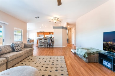 4656 E DI Living area featuring a ceiling fan, lig