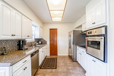 Kitchen - the door at the end of the kitchen is the large walk-in pantry