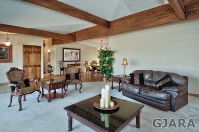 Wood-beamed ceilings accent a classy entertaining 