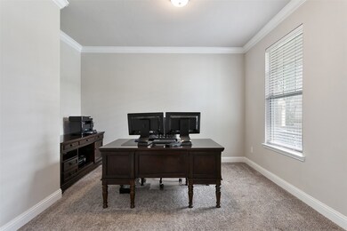 Private study has French doors, crown molding and views of your front porch.