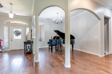 Entryway featuring crown molding, and hardwood / w