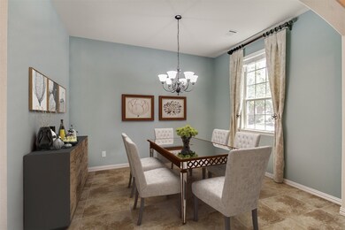 You and your guests will certainly dine in style in this amazing formal dining room! This space features a modern chandelier, large windows, neutral custom paint, high ceilings that contrast the walls, and tile flooring! Perfect space to entertain family and friends!