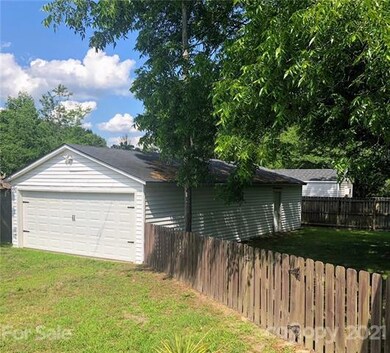 Separate 4 car garage with doors at both ends and 