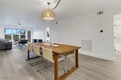 Dining space with wood porcelain tile floor, with