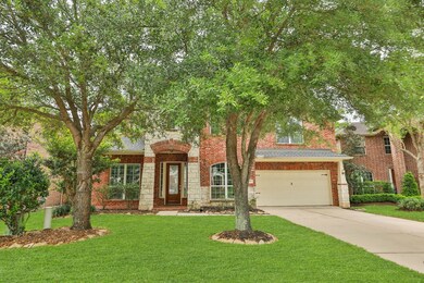 The front yard features elegant trees and vibrant