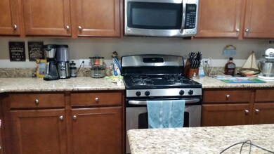 Kitchen has a gas range.