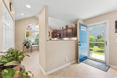 Foyer entrance with vaulted ceiling and light tile