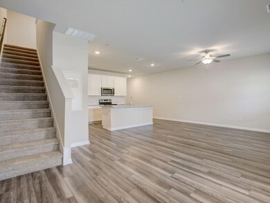 Unfurnished living room with a ceiling fan, light