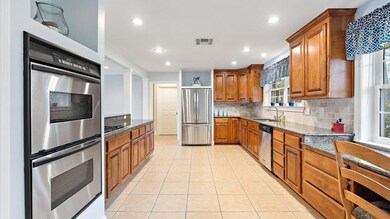 Large kitchen features stainless steel appliances,