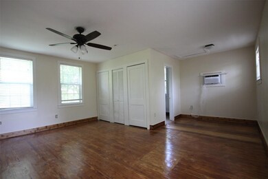 Unfurnished bedroom with two closets, wood finish