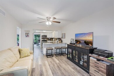 Living room featuring light wood-style floors and a ceiling fan