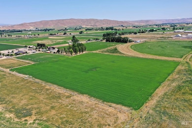 Aerial view of sparsely populated area featuring mountains and large plots for crops