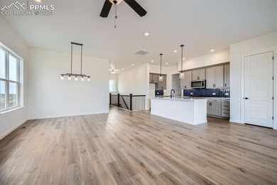 Kitchen with a kitchen island with sink, hanging l