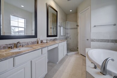 Primary bathroom has double sinks, granite vanity,