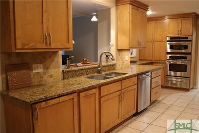 Pretty granite counters with neutral tile backspla