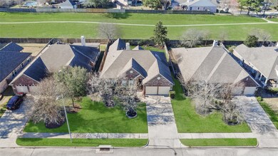 Aerial view of the front of the home with the gree
