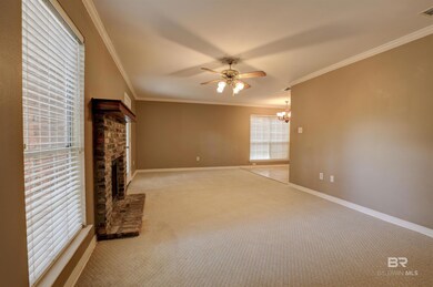 Unfurnished living room with ornamental molding, carpet floors, and a fireplace