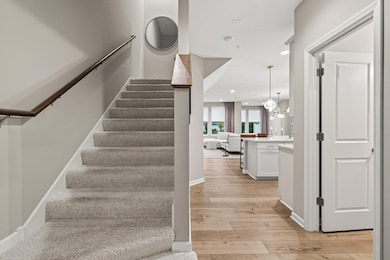 As you step inside, you are greeted by a beautifully clean, minimalist entryway.  The open floor plan draws your attention toward the stunning living area just beyond.
