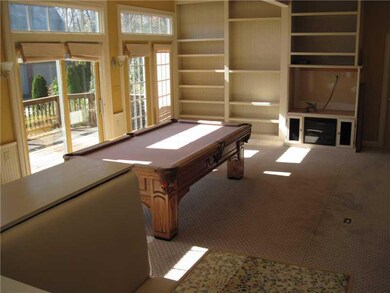 Living Room. Hobby room , lounge or  extra family room with walk out to the upper deck. Water views and Golf course!