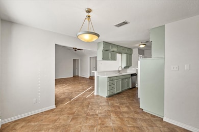 Kitchen featuring green cabinetry, light countertops, pendant lighting, and ceiling​​‌​​​​‌​​‌‌​​‌​​​‌‌​​​​​​‌‌‌​​‌​​‌‌​​​‌ fan