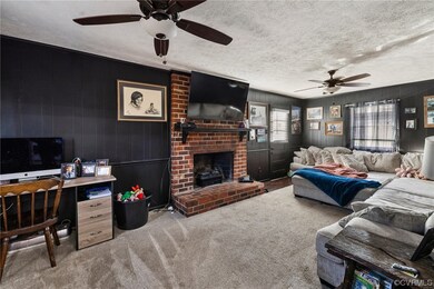 Carpeted living room featuring a brick fireplace,