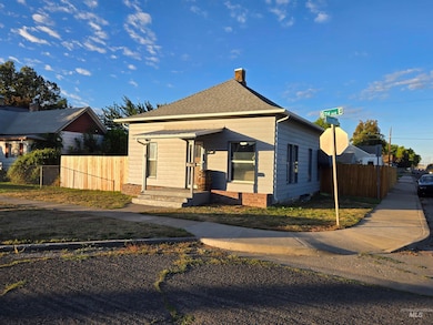View of front of home featuring a chimney and a shingled roof