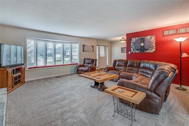 Large living space with newer carpet and fantastic window seat for watching the evening sunset, or read a book.