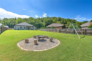 Spacious level backyard. Firepit and tether ball convey.