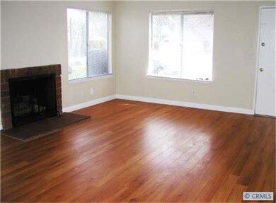 Spacious Living Room with Newer Laminate Floors and Fireplace