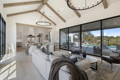 Living room with a chandelier, high vaulted ceili