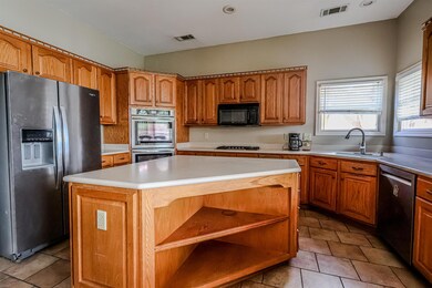 Kitchen featuring open shelves, a center island, a