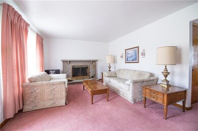The living room features a log burning fireplace t