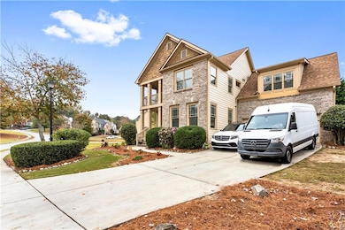 View of front facade with concrete driveway, brick