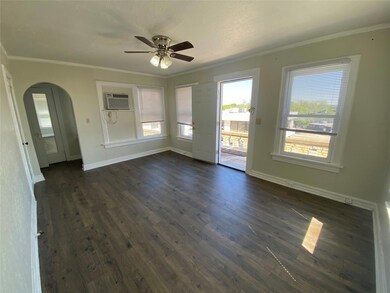 Unfurnished room featuring dark hardwood / wood-style flooring, ceiling fan, a wall mounted AC, and crown molding