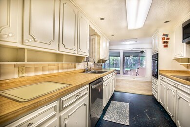 Kitchen with butcher block counters, stainless ste