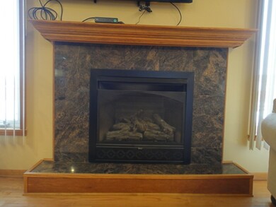 Gas Fireplace with Granite Surround and Oak Mantle