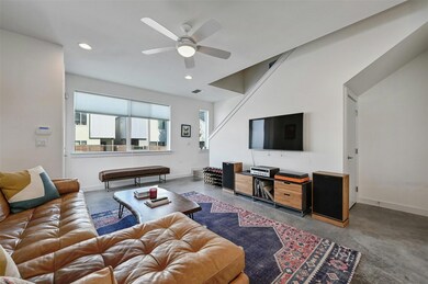 Living area with recessed lighting, concrete floo