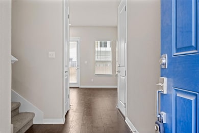 Entrance foyer with dark wood finished floors, ba