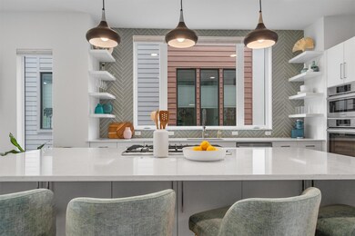 Kitchen featuring white cabinetry, a kitchen bar,