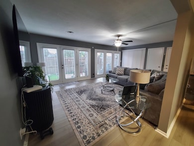 Living room with plenty of natural light, ceiling fan, and wood finished floors
