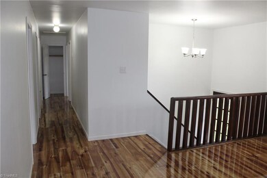 View of hallway from living room on upper level.