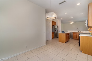 Kitchen featuring kitchen peninsula, hanging light