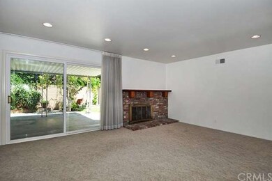 Large living room/dining room with brick fireplace