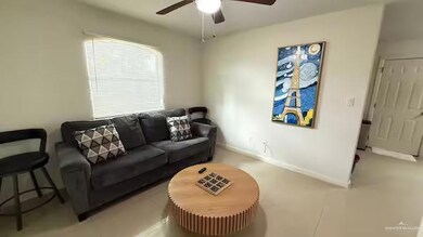 Living room with a ceiling fan and baseboards