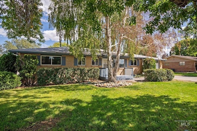 Single story home with a front yard and brick siding
