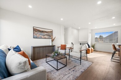 Living area featuring light wood finished floors and recessed lighting