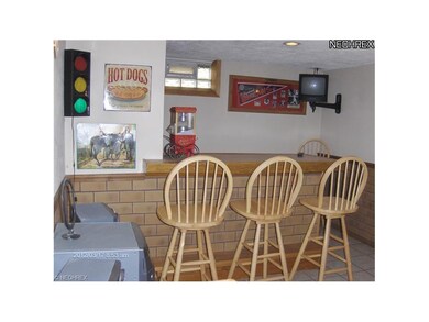 Lower Level Bar Room with ceramic tile floor.  bar Stools and TV stay