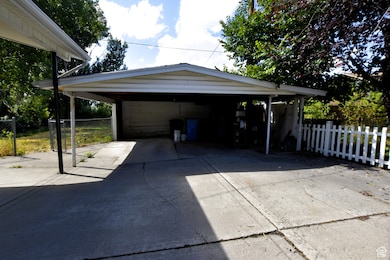 Garage featuring a detached carport