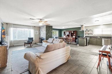 Living room with wood finish floors and a ceiling fan