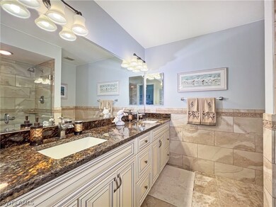 Bathroom with tile patterned floors, double sink v